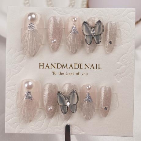 A085   Dive into elegance with these handcrafted mermaid tail, cat-eye nails adorned with butterfly pearls and an almond finish handmade press on nails.